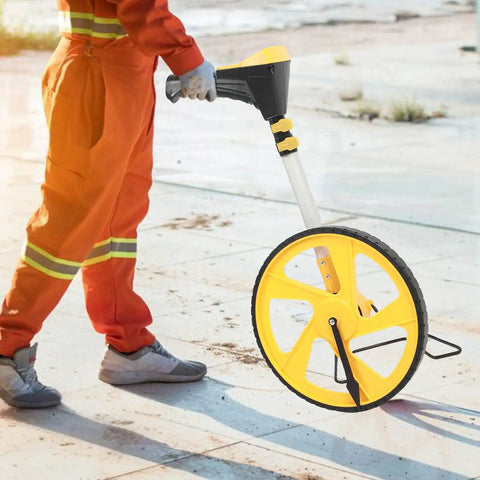 Roll Out Precision Digital Measuring Wheel With Bright Backlit LCD Display And Telescoping Handle in use on a job site.