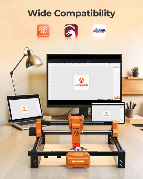 ACMER laser engraver machine on desk; orange-black frame with 300x300mm engraving area and 7000mW laser