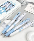 Four Pack Cute Retractable Gel Pens Blue Star 0.5mm Fine Point Black Ink set displayed on a mirror with packaging box.
