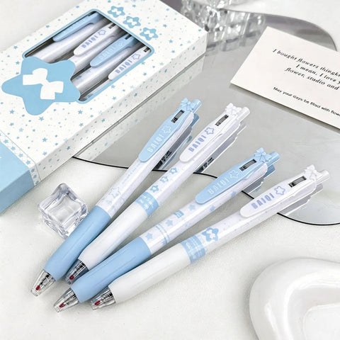 Four Pack Cute Retractable Gel Pens Blue Star 0.5mm Fine Point Black Ink set displayed on a mirror with packaging box.