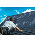 Rock Solid Beat The Heat Ice And Water Shield Roofing Underlayment Self Adhering Rubberized Asphalt applied by roofer on sloped roof.