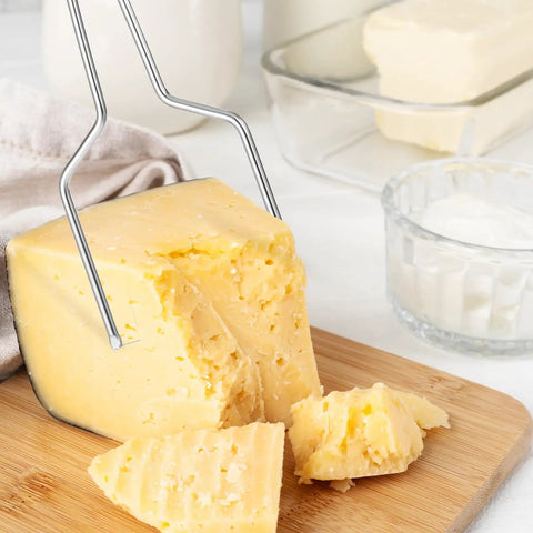 Heavy Duty Stainless Steel Cheese Slicer Wire And Y Type Cutter With Twist Lock Kitchen Workhorse For Cheese Boards And Meal Prep No Drama Total Game Changer Dishwasher Safe cutting through cheese block.