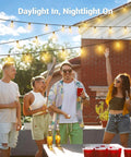 Group enjoying 200 Foot Solar String Lights Outdoor Waterproof With Remote Control on a patio during a sunny day.