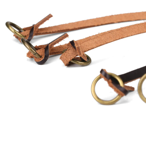 Close-up of leather game carrier strap with 12 drop slip rings for dove, duck, quail, pheasant, and small game bird tote hanger.