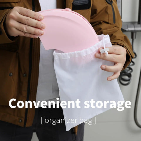No Sweat Portable Potty For Toddler Pink Travel Training Seat being stored in a white organizer bag for easy transport.