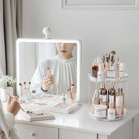 Two Tier Clear Rotating Vanity Organizer With Smooth 360 Degree Spin For Skincare And Perfume Beauty Essentials Storage on a bathroom countertop.