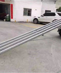 Smooth Rolling Gravity Roller Conveyor With Abs Plastic Wheels And Precision Bearings Unpowered Flow Track in a loading dock setting.
