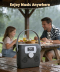 Portable CD Player With Bluetooth Boombox And Built In FM Radio For Camping And Travel Waterproof on picnic table in rain