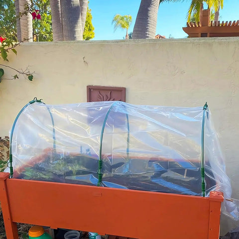 Mini Greenhouse Tunnel For Outdoors with PVC cover on a raised bed, backyard garden setup