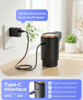 Portable Electric Water Jug Dispenser With USB C Charging Dual Motors For 2 To 5 Gallon Jugs Fast Flow Ideal For Home Office Camping And RV Use Dark Black shown charging on a table with USB-C cable.