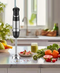 Heavy Duty Corded Hand Blender With Knockout Copper Motor And Twelve Speed Settings Plus Quick Pulse Turbo on kitchen counter with fruits and soup.