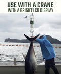 Heavy Duty Digital Crane Scale With Clear LCD Screen Built Tough For Real World Jobs Straight Shot Weighing Up To Six Thousand Pounds monitoring a large fish.