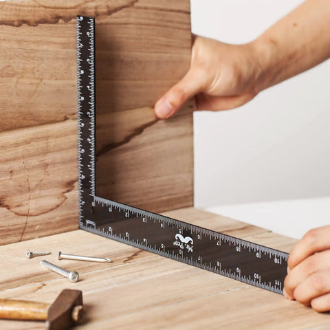 Metal Carpenter Square Ruler L Shape Right Angle 8 By 12 Inch With Imperial And Metric Measurements One Sixteenth Inch Graduations held on wood