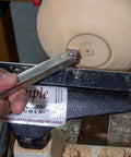 Carbide 90 Detailer wood lathe turning tool, stainless steel, unhandled, held in hand while shaping spinning wood