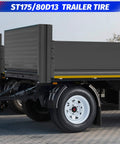 Side view of Trailer Tire And Wheel Set With ST175/80D13 Tire On 13 Inch Rims, 5 Lug On 4.5 Inch Bolt Pattern, Load Range C, 6PR, 50 Psi Max, White 13x5 Wheels, Set Of 2 installed on a trailer.