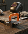 Heavy Duty Orange Iron G-Clamp For Woodworking And Diy Projects. 1 Inch Adjustable C Clamp securing metal on a workbench.