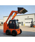 Workhorse Mini Track Skid Steer Loader with raised bucket at construction site, compact flexible equipment for efficient job site performance
