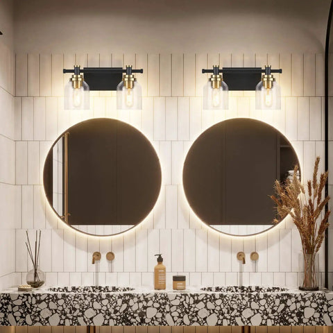 Vintage Two Light Bathroom Wall Sconce In Black Brass With Clear Glass above round mirrors in modern bathroom