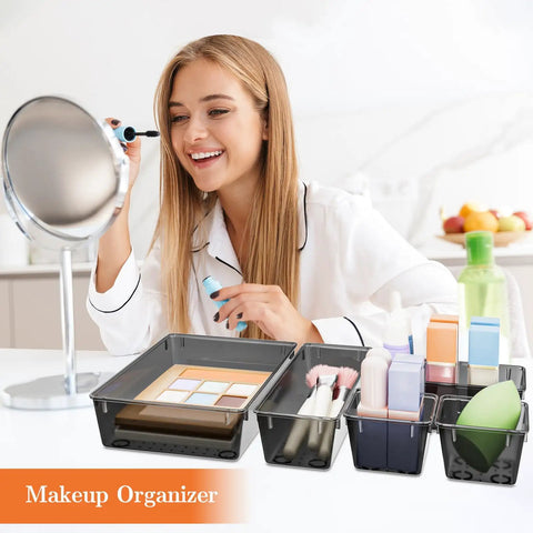Woman using makeup with 25 Piece Plastic Drawer Organizer Set With 4 Size Versatile Trays And Storage Bins For Makeup Jewelry Gadgets In Bathroom Bedroom And Office Clear Black in foreground.
