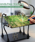 Pro Grade Helping Hands Soldering Station With Five X Magnifying Lamp And Four Flexible Arms PCB Holder No Slip Base in use
