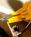 Yellow mini wire stripper from 6 Piece Mini Wire Stripper Set With Sharp Blades For RJ45 Cat5 Cat6 Cables in action on wire