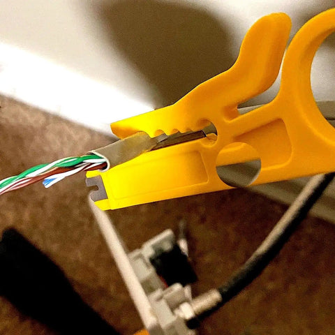 Yellow mini wire stripper from 6 Piece Mini Wire Stripper Set With Sharp Blades For RJ45 Cat5 Cat6 Cables in action on wire