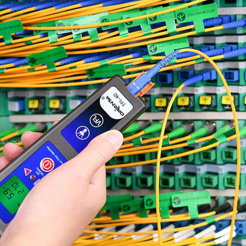 Person using All In One Optical Fiber Identifier With 10 mW VFL And 800 To 1700 Nanometers Fiber Detector, cables around