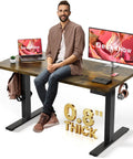 Electric Motorized Sit Stand Desk Adjustable Workstation 48 X 24 Inch Thick Desktop with 0.8 inch surface in home office setup.