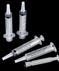 Large Plastic Syringe 4 Pack For Measuring And Dispensing Fluids Sterile Wrapped 20 Ml Syringe Set lying on black background