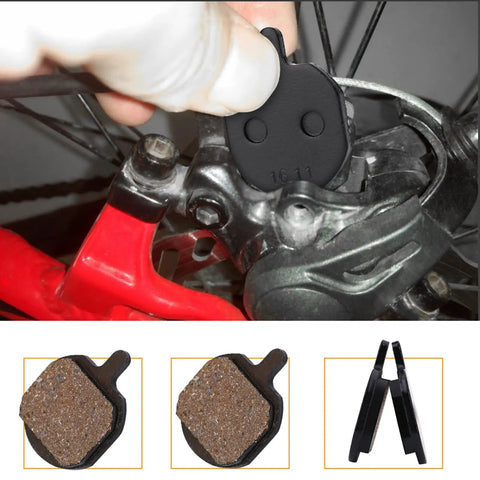 4 Pairs Mountain Metallic Disc Brake Pads For Bikes in resin type being installed on a bicycle for smooth stops and heat dissipation