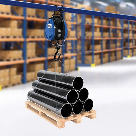 Heavy Duty Electric Chain Hoist, 1100 Lb Capacity With 1800 Watt Motor lifting black pipes on a wooden pallet in a warehouse.