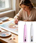 Badass Cordless Electric Pickup Pen With Reliable Vacuum Grip To Snag Loose Bits Zero Sweat For Desk Projects Plus Bright Light and Smooth Angled Tip For Crisp Workflows in pink with beads on a crafting table.