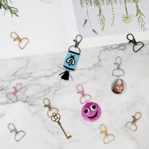 Top Shelf Swivel Clasp Clip Hooks 60 Pack For Keychain Making And Lanyards Featuring Badass D Ring Metal Hardware detail on marble background.