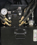 Hydraulic components of the Tough Three Roll Hydraulic Metal Bender featuring motors, gauges, and hoses for efficient metal bending.