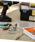 Built Tough Four Pack Fish Eye Threaded Rod End Bearings Featuring Durable Copper Housings set on a workbench with tools and screws.