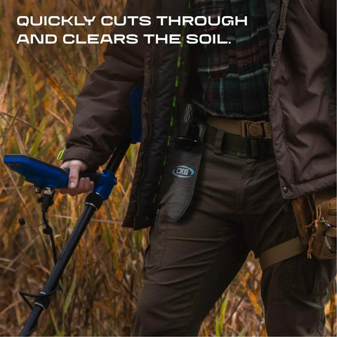 Man holding a metal detector and a Beefy Heavy Duty Metal Detecting Shovel With Double Serrated Blade in outdoor setting.