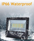 JUDYSSY Led Floodlight 100W Led Solar Flood Lights, IP66 waterproof design, illuminated in splashing water.