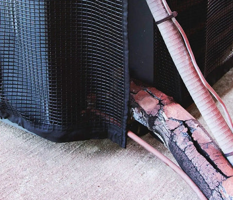 Close-up of AC Defender Full Mesh Outdoor Air Conditioner Cover for All Season Protection on concrete, showing mesh texture and fit.