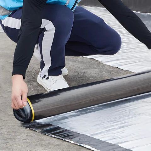 Person installing Top Shelf Self Adhesive Roofing Felt Repair Tape, 3.3 x 32.8 ft, on a flat surface for leak sealing.