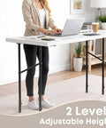 Woman using a laptop at a table with Four Pack Legit Heavy Duty Table Leg Extenders Adjustable Risers for height adjustment.