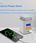 Two Way Battery Charging Hub For Mini 3 Pro Drone Batteries with phone charging via USB, showing smart power display.