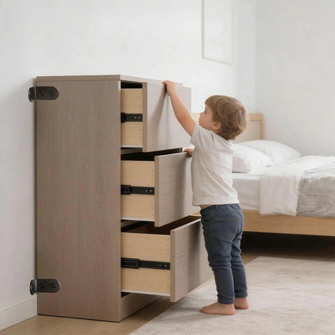 Child near dresser secured with Anti Tip Furniture Anchor Kit For Baby Proofing Dresser And Bookcase, Easy Wall Mount, Black.