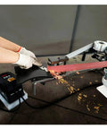Heavy-Duty Shop Beast 71 Inch Belt Grinder in use, showing sparks during metal grinding with vertical adjustment.