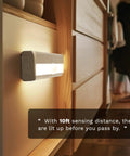 6 Pack Motion Sensor Lights For Closets And Stairs, 10 LED Battery Operated Night Lights stuck to wooden cabinet, sensing nearby movement.