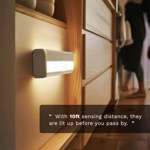 6 Pack Motion Sensor Lights For Closets And Stairs, 10 LED Battery Operated Night Lights stuck to wooden cabinet, sensing nearby movement.