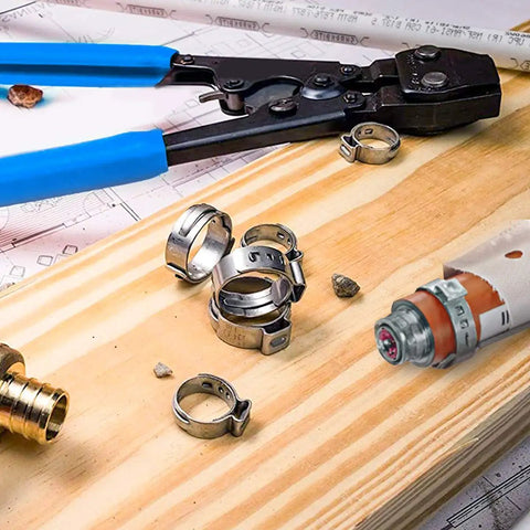 Stainless Steel PEX Cinch Clamp Rings 3/4 Inch Pack Of 50 with clamp tool and PEX tubing on wooden board