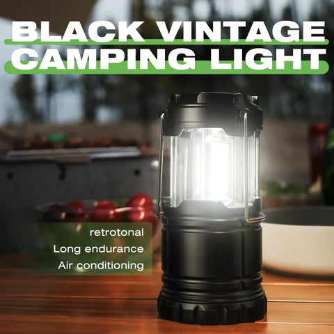 Black vintage LED lantern glowing on a table, part of Collapsible Camping Lantern 4 Pack Battery Operated LED Super Bright Light.