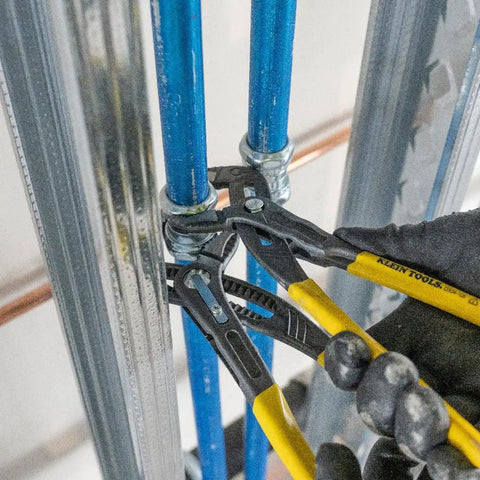 Using 10 Inch Quick Adjust Tongue And Groove Pliers with Push Button Ratchet on plumbing pipes in tight space