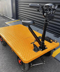 Huge Heavy Duty Electric Platform Truck Cart That Folds Like A Dream For Moving Groceries And Warehouse Gear With Slip Resistant Surface Holding Up To 2K Lbs, orange foldable cart with a textured surface and handle.