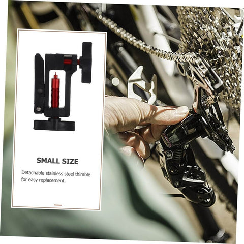 Hydraulic Hose Fitting Insert Tool For Bicycles With Needle Driver And Detachable Thimble Lock being used on bike chain